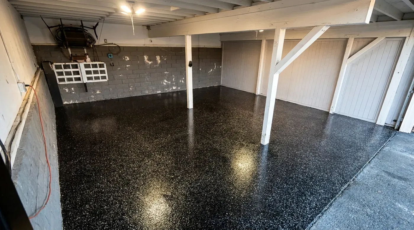 Glossy dark flake floor in a covered space with white columns